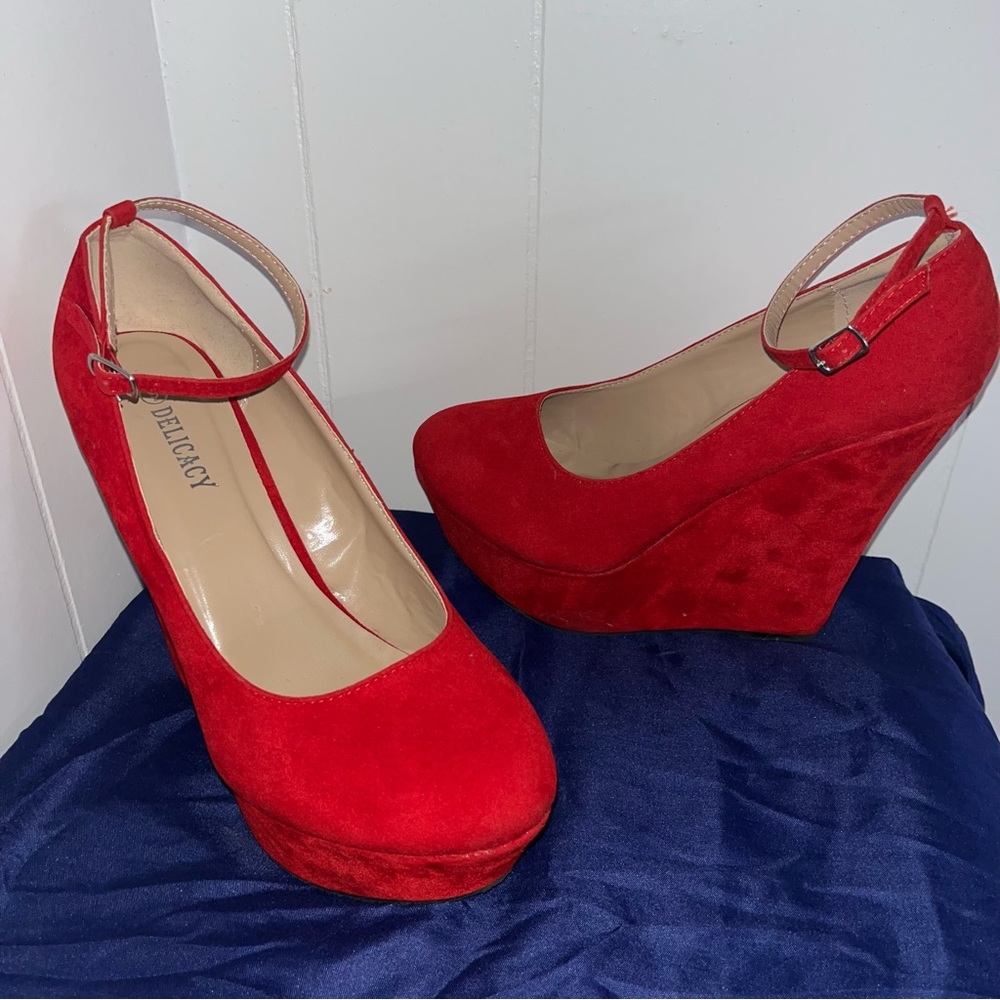 Red wedge heels with an ankle strap.